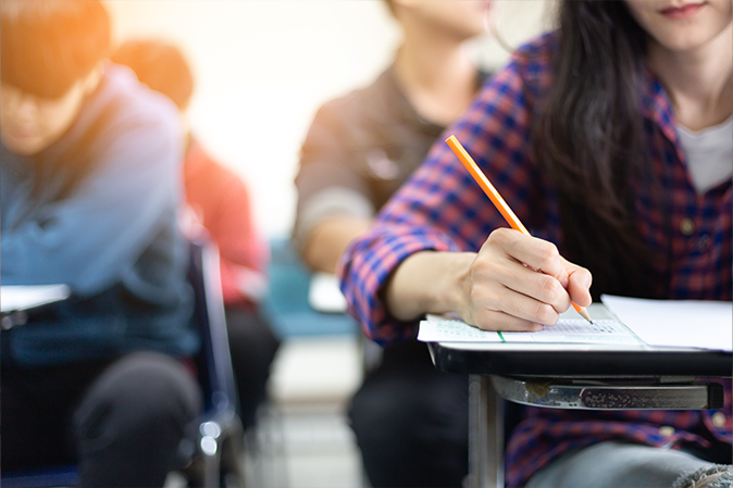 students taking a test in a classroom