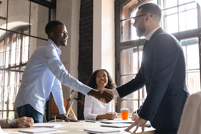 Two men shaking hands at meeting
