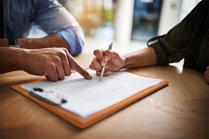 Lawyer, broker or HR manager signing a contract agreement with client or employee. Financial advisor asking for womans signature for insurance, legal paperwork or claim document.