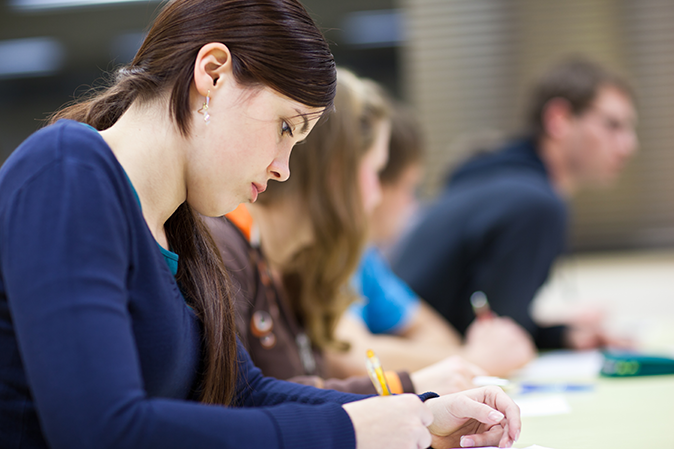 Young woman in classroom taking an exam