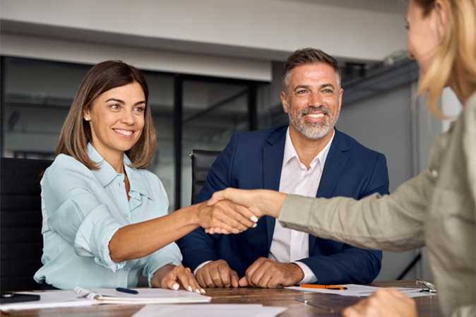 Professional colleagues shaking hands with business partner