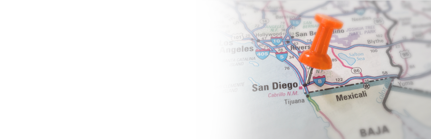 Orange pushpin marking San Diego on a Southern California map near the Mexico border