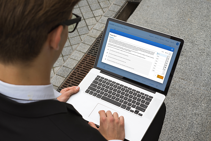 Young man outside typing on his laptop