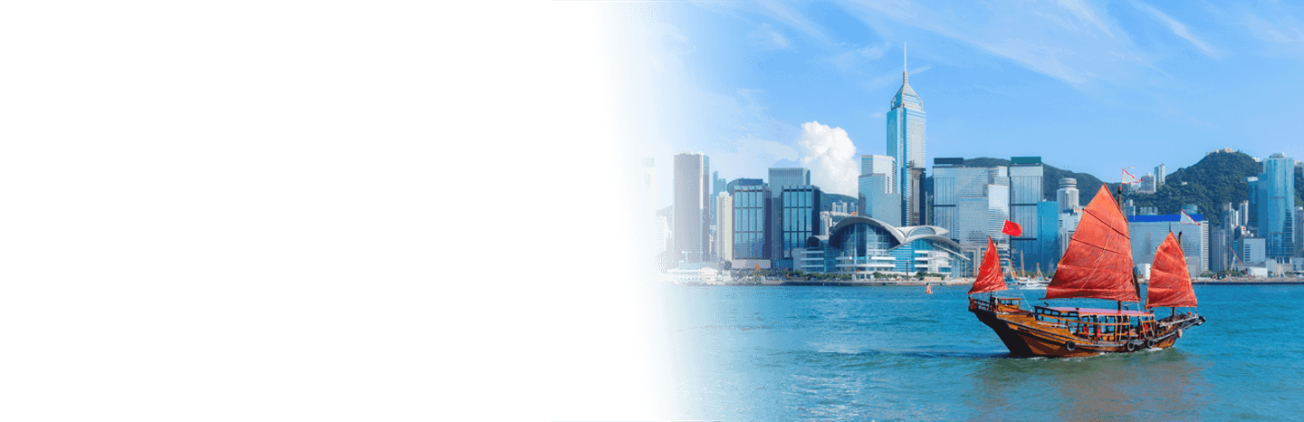 Traditional sailboat on the water with a city skyline in the background