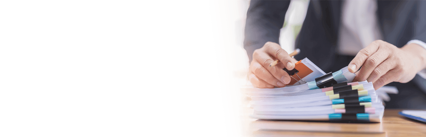 A business man going through a stack of files