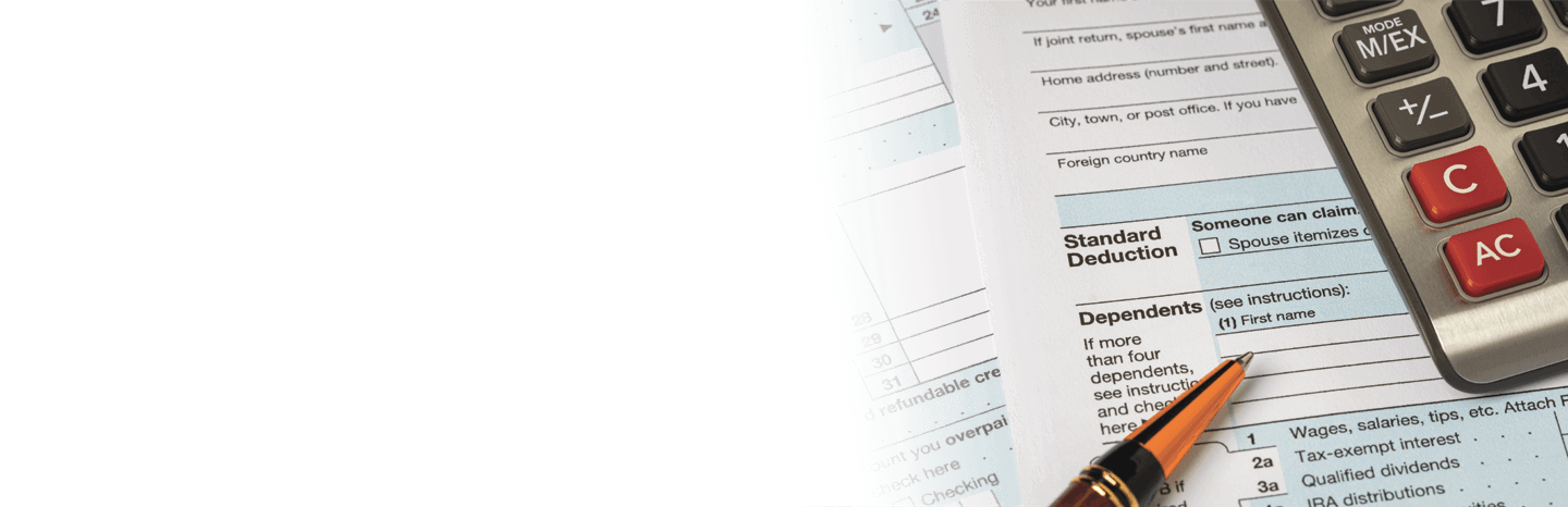 Tax form with a calculator and a pen