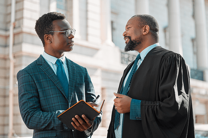 Young lawyer talking to a judge outside