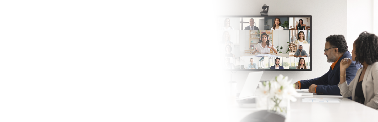 A couple of professionals in a modern office engaged in a video conference with other people