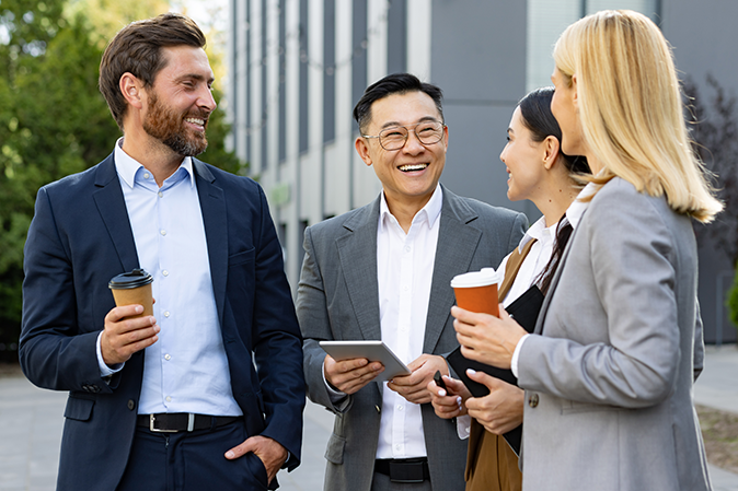 Group of professionals chatting outside together