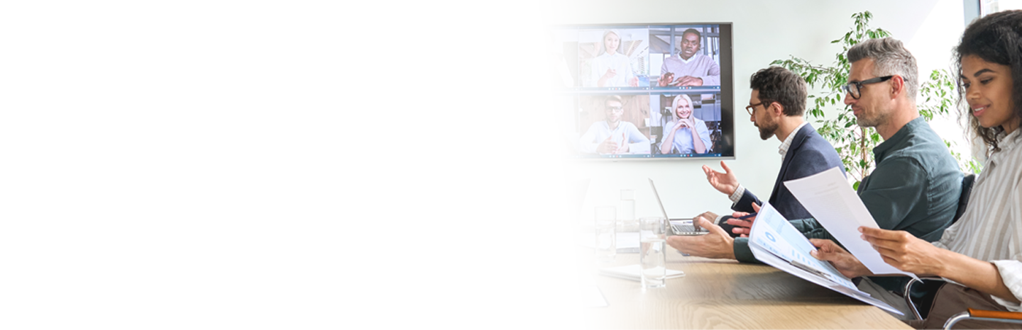 People in a meeting with a video conference on the wall TV