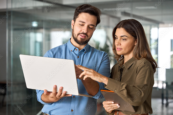 Young man and woman working on a laptop together