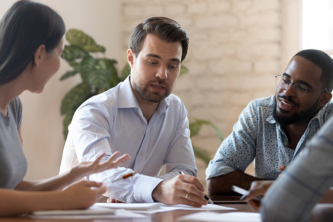 Three coworkers collaborating on a project in an office